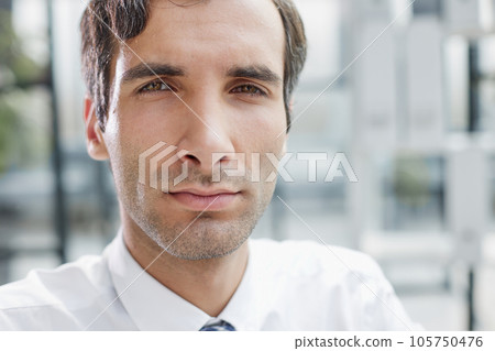 Portrait closeup of serious concentrated businessman wearing white shirt looking at camera, 105750476