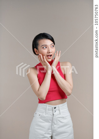 Young asian female amazed with happiness in positive shock cheering to good amazing news 105750763