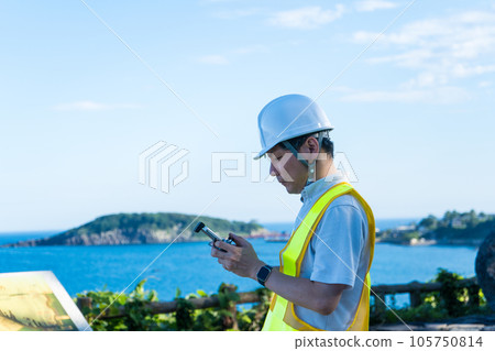 Male worker operating a drone at the beach | Drone image | Inspection image 105750814