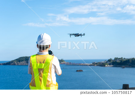 Male worker operating a drone at the beach | Drone image | Inspection image Male worker operating a drone at the beach | Drone image | Inspection image 105750817