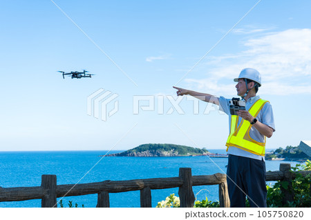 Male worker operating a drone at the beach | Drone image | Inspection image Male worker operating a drone at the beach | Drone image | Inspection image 105750820