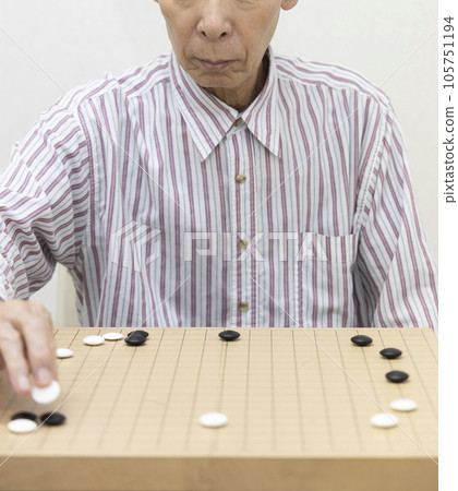 Hobbies: A man who enjoys playing Go 105751194