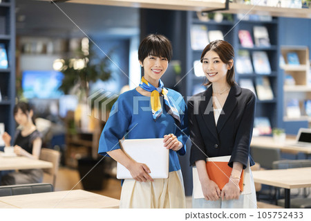 Two businesswomen smiling at the camera 105752433