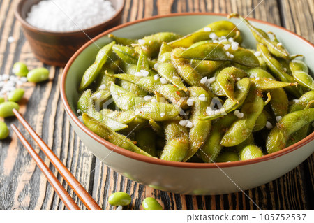 Stir-fried green soy beans edamame seasoned garlic and salt closeup on the plate. Horizontal 105752537