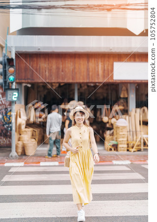 Young asian woman traveler in dress with hat traveling to wicker shop on Chang Moi Kao Road, Tourist visit at the old city in Chang Mai, Thailand. Asia Travel, Vacation and summer holiday concept Young asian woman traveler in dress with hat traveling to wicker shop on Chang Moi Kao Road, Tourist visit at the old city in Chang Mai, Thailand. Asia Travel, Vacation and summer holiday concept 105752804