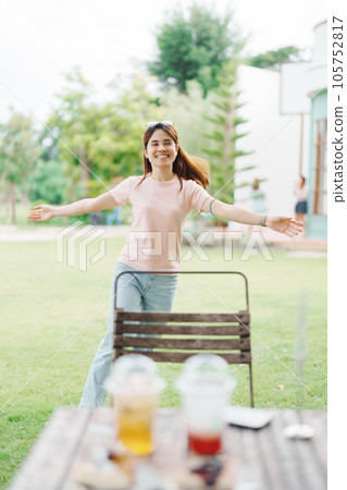 Happy woman with Dessert in cafe, young Asian girl smiling during eating cake and drinking ice beverage at home Happy woman with Dessert in cafe, young Asian girl smiling during eating cake and drinking ice beverage at home 105752817