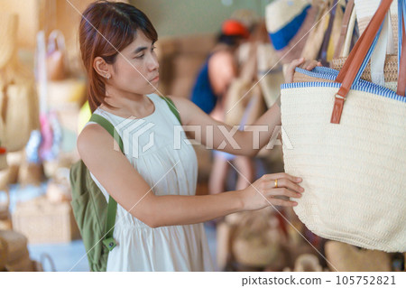 woman hand holding handcraft basket in wicker shop, Tourist visit at the old city in Chang Mai, Thailand. Asia Travel, Vacation and summer holiday concept 105752821