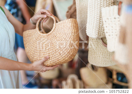 woman hand holding handcraft basket in wicker shop, Tourist visit at the old city in Chang Mai, Thailand. Asia Travel, Vacation and summer holiday concept woman hand holding handcraft basket in wicker shop, Tourist visit at the old city in Chang Mai, Thailand. Asia Travel, Vacation and summer holiday concept 105752822
