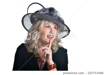 senior woman wearing black hat with silence gesture 105753486