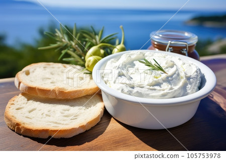 Close up view of tzatziki on Greek table, sea in background. Close up view of tzatziki on Greek table, sea in background. 105753978