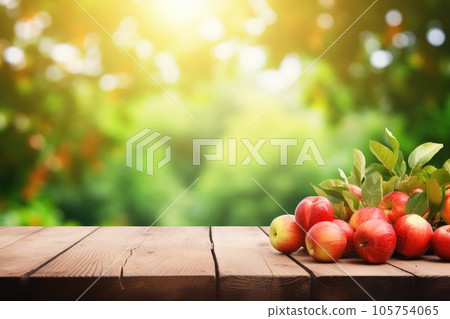 Wooden table top on blurred background orchard with apples 105754065