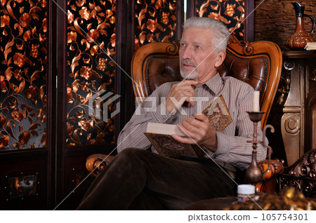 old man preparing dinner in kitchen old man preparing dinner in kitchen 105754301