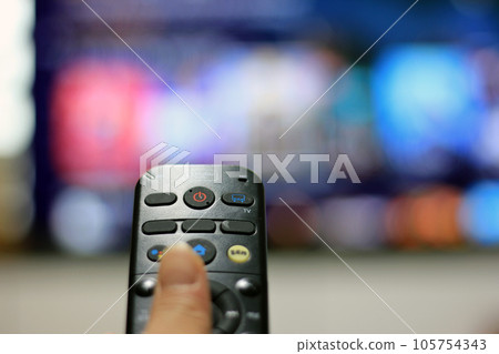Cord Cutters Watching tv and using remote control 105754343