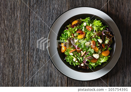 Mandarin Orange Salad in black bowl, top view 105754391