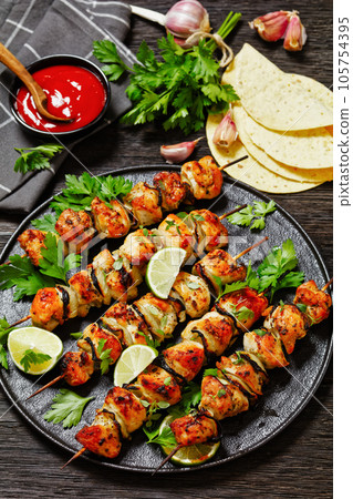 chicken souvlaki with parsley and lime on plate 105754395