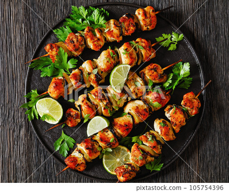 chicken souvlaki with parsley and lime on plate 105754396