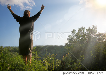 Happy girl pray to God 105754774