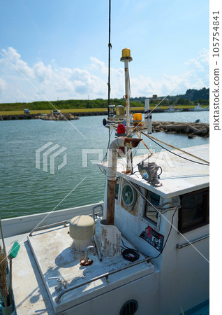 A boat floating in the summer blue sea A boat floating in the summer blue sea 105754841