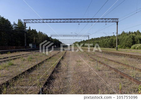 an old railway with metal rails on which trains rarely travel 105755096