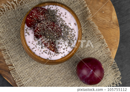 flavored pink yogurt with ripe and sweet plum flavored pink yogurt with ripe and sweet plum 105755112