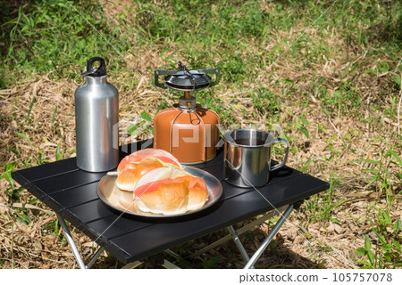 Sandwich with camping equipment and buns on aluminum table Sandwich with camping equipment and buns on aluminum table 105757078