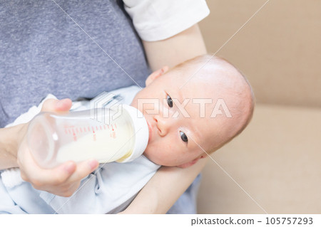 Newborn baby drinking milk from a baby bottle photo material 105757293