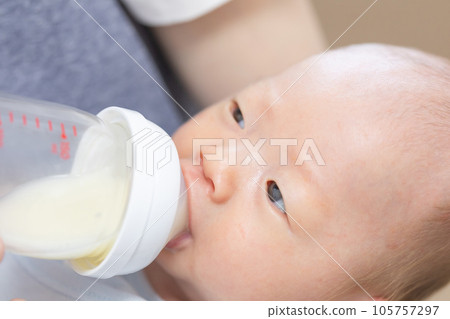 Newborn baby drinking milk from a baby bottle photo material 105757297