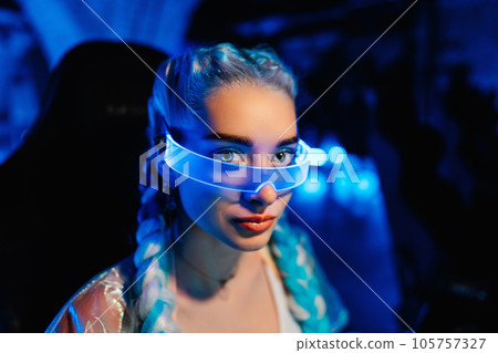 Gamer blogger in neon glasses. Portrait of a young woman in the style of cyberpunk. 105757327