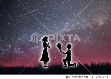 A silhouette of a confessing man with a bouquet in his hand and a surprised woman. A proposal under a starry sky. 105757731