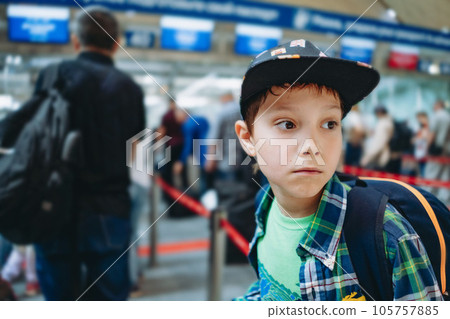 sad caucasian boy in airport with backpack and suitcase. Travelling concept sad caucasian boy in airport with backpack and suitcase. Travelling concept 105757885