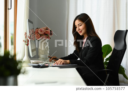 Attractive female economist working with graph and statistic document on office desk Attractive female economist working with graph and statistic document on office desk 105758577
