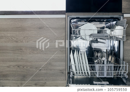 Close-up of opened automatic stainless built-in dishwasher machine inside modern home kitchen with clean utensil. Household, housekeeping domestic life. Household chores, daily home routine, housework Close-up of opened automatic stainless built-in dishwasher machine inside modern home kitchen with clean utensil. Household, housekeeping domestic life. Household chores, daily home routine, housework 105759550
