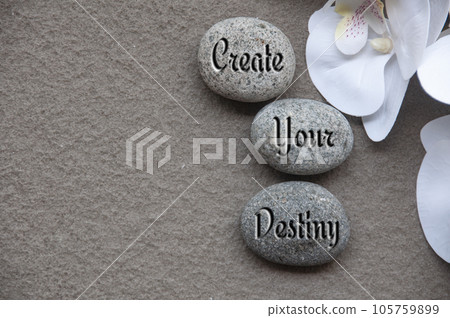 Top view of motivational quote text on rocks - Create your destiny. Motivational concept. Top view of motivational quote text on rocks - Create your destiny. Motivational concept. 105759899