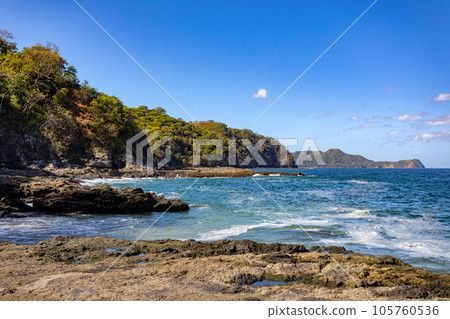 Playa Ocotal and Pacific ocean waves on rocky shore, El Coco Costa Rica 105760536
