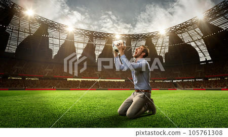 Man standing on knees on football arena, holding ball, shouting, celebrating win of money. Successful betting. 3d render 105761308