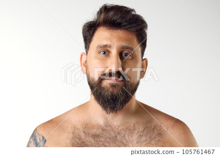 Portrait of handsome bearded mature man with blue eyes posing shirtless against white studio background. Spa 105761467