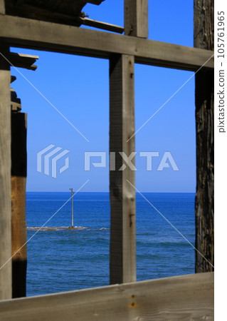 The window of the boathouse and the utility pole floating in the sea The window of the boathouse and the utility pole floating in the sea 105761965