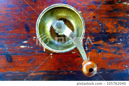 An antique coffee grinder on the table in the garden. An antique coffee grinder on the table in the garden. 105762040