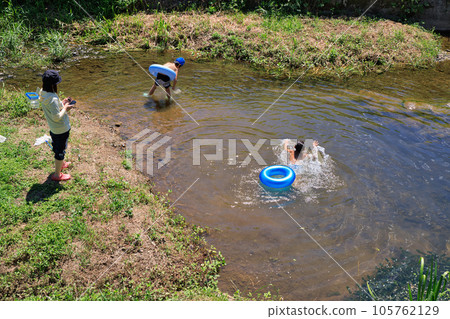 Children enjoying water play in a small river 105762129