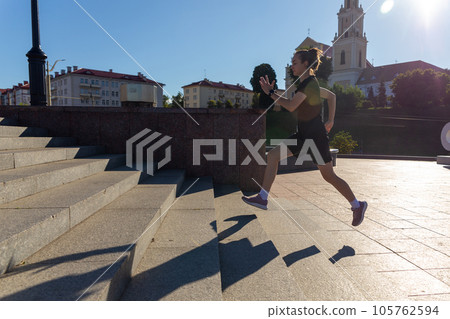 A young woman in black clothes running on stairs 105762594