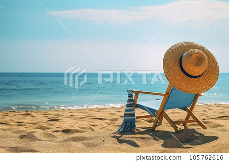 Sun lounger on a paradise beach by the sea with a straw hat hanging on it 105762616