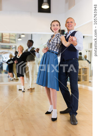 Man and woman dancing waltz in studio 105763948