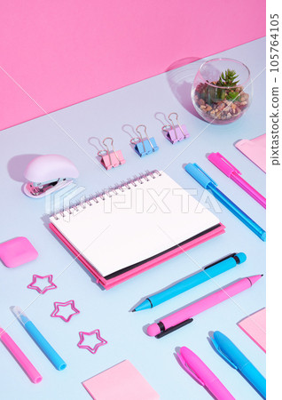 Stationary background with pink, blue and violet pens, clips on magenta and cyan backdrop. Stationary background with pink, blue and violet pens, clips on magenta and cyan backdrop. 105764105