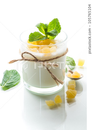 Sweet homemade yogurt with candied fruits in a glass Sweet homemade yogurt with candied fruits in a glass 105765104
