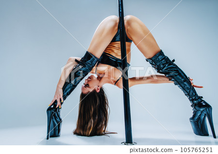 Woman pole dancing 105765251