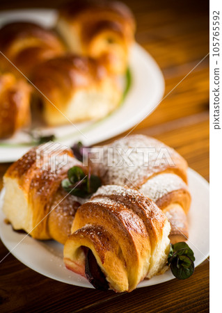 baked sweet homemade buns with plum inside 105765592