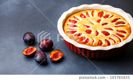 Homemade plum pie with almond flour in ceramic baking pan Homemade plum pie with almond flour in ceramic baking pan 105765835