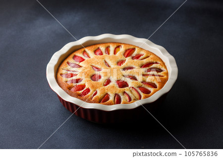 Homemade plum pie with almond flour in ceramic baking pan Homemade plum pie with almond flour in ceramic baking pan 105765836