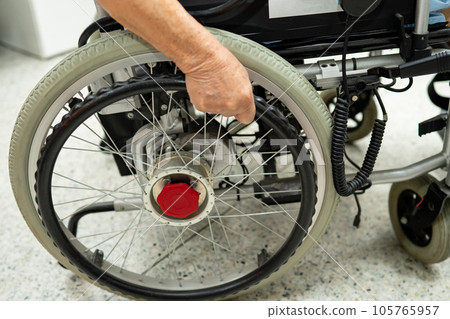 Asian senior woman patient on electric wheelchair with remote control at hospital, healthy strong medical concept. Asian senior woman patient on electric wheelchair with remote control at hospital, healthy strong medical concept. 105765957