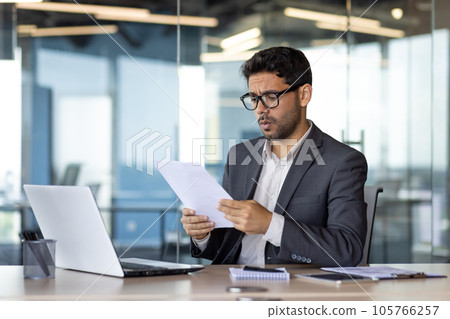 Upset financier investor checking accounts and contracts financial reports, businessman unhappy and disappointed with achievement results at workplace using laptop for paper work. Upset financier investor checking accounts and contracts financial reports, businessman unhappy and disappointed with achievement results at workplace using laptop for paper work. 105766257